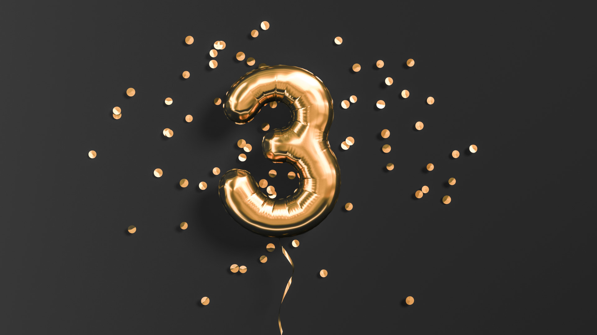 A foil balloon in the shape of the number three